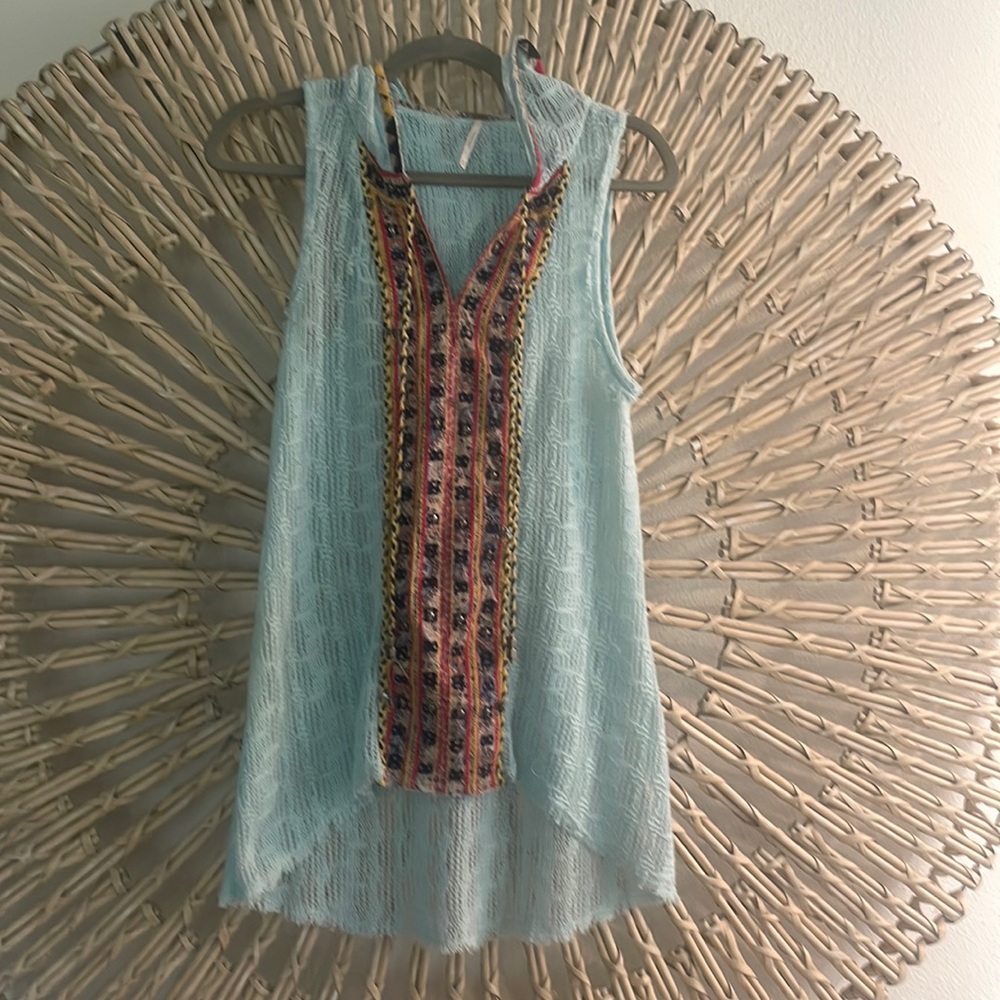 Free People XS sleeveless tunic wit hold.  Slightly distressed.Beautiful colors